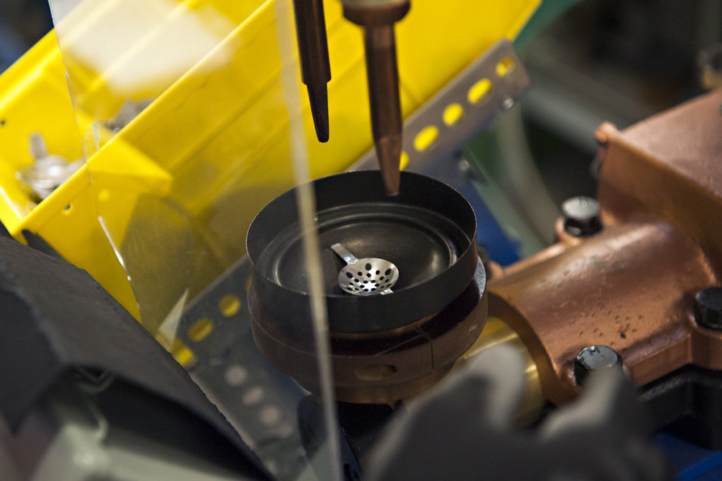 Spot-welding the gas distributor into the burner cup.