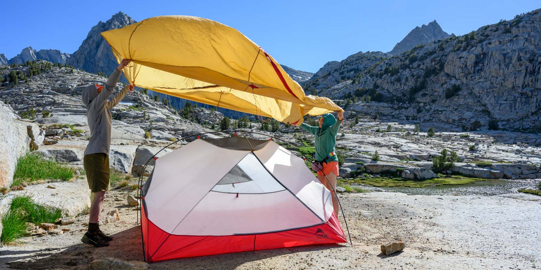 Backpackers setting up MSR tent