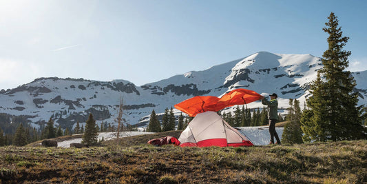 Woman placing fly over tent